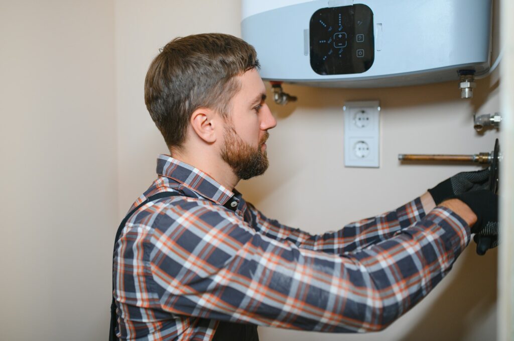 worker set up central gas heating boiler at home