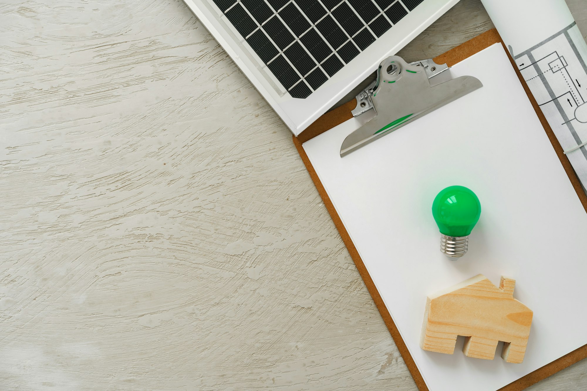 Wooden house miniature and solar panel close up